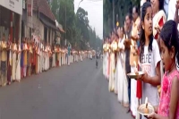 Ayyappa jyothi volunteers line up with lamps lit on kerala public roads