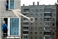 Toddler balances on the ledge of an eighth floor window